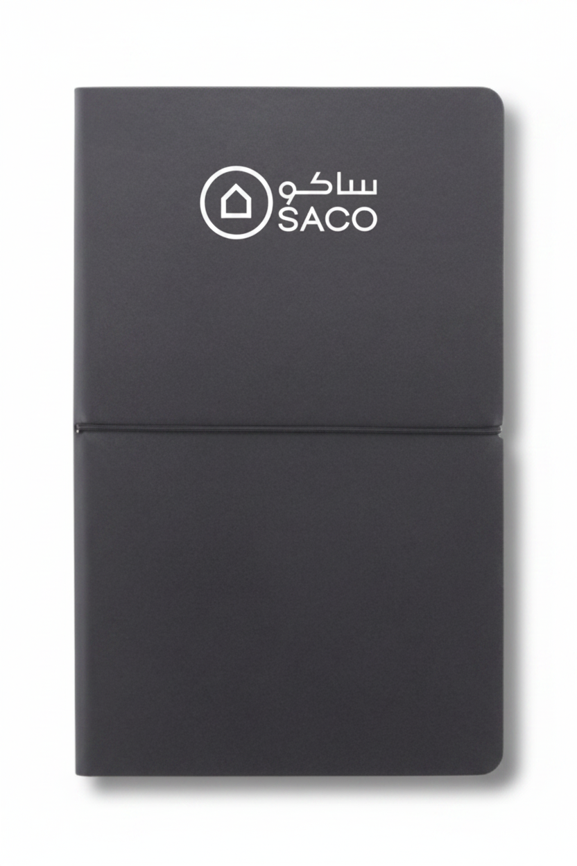 Dark grey notebook with SACO logo in white on top