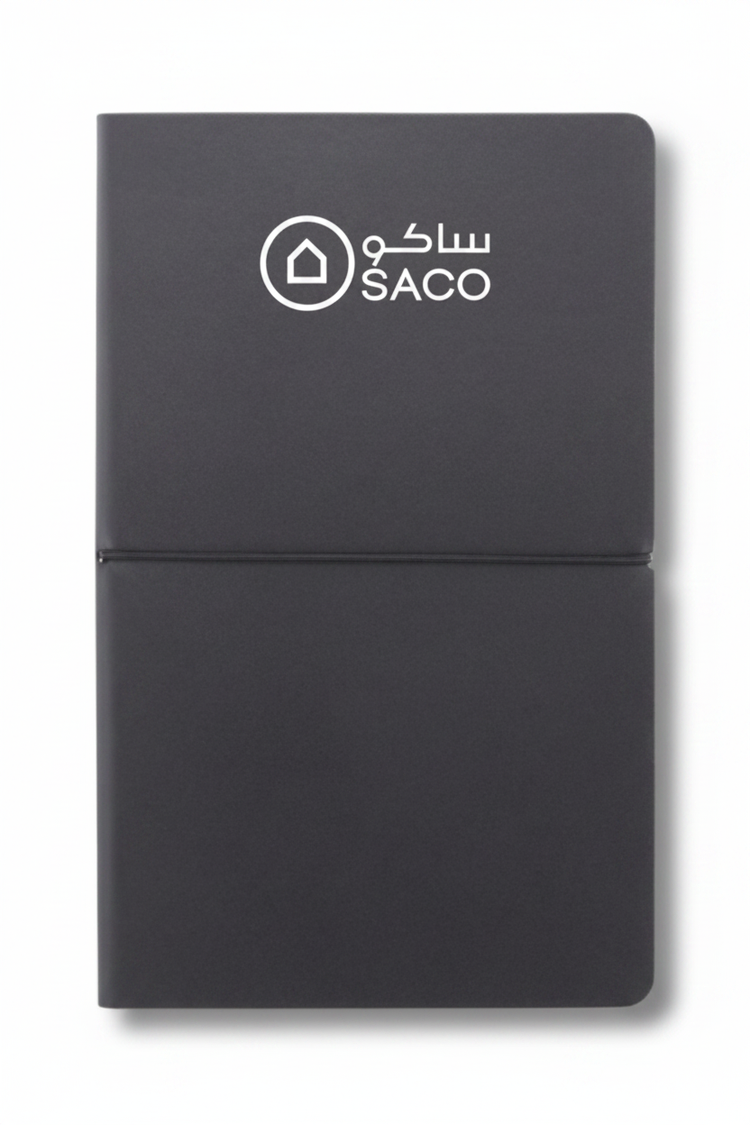 Dark grey notebook with SACO logo in white on top